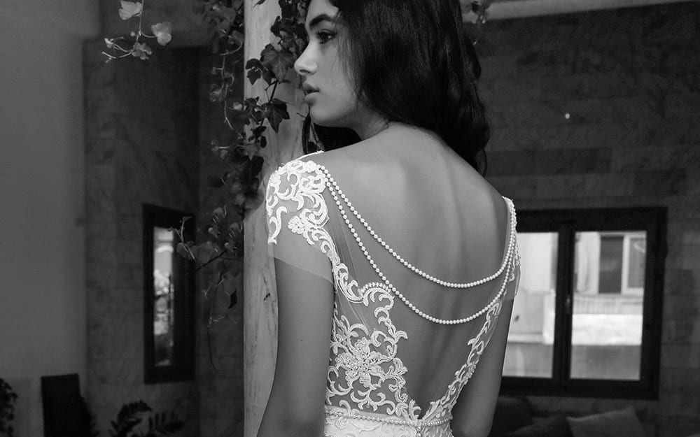 Hadar by studio levana deep v nackline with baeded lace wedding dress short sleeves and pearls on the back