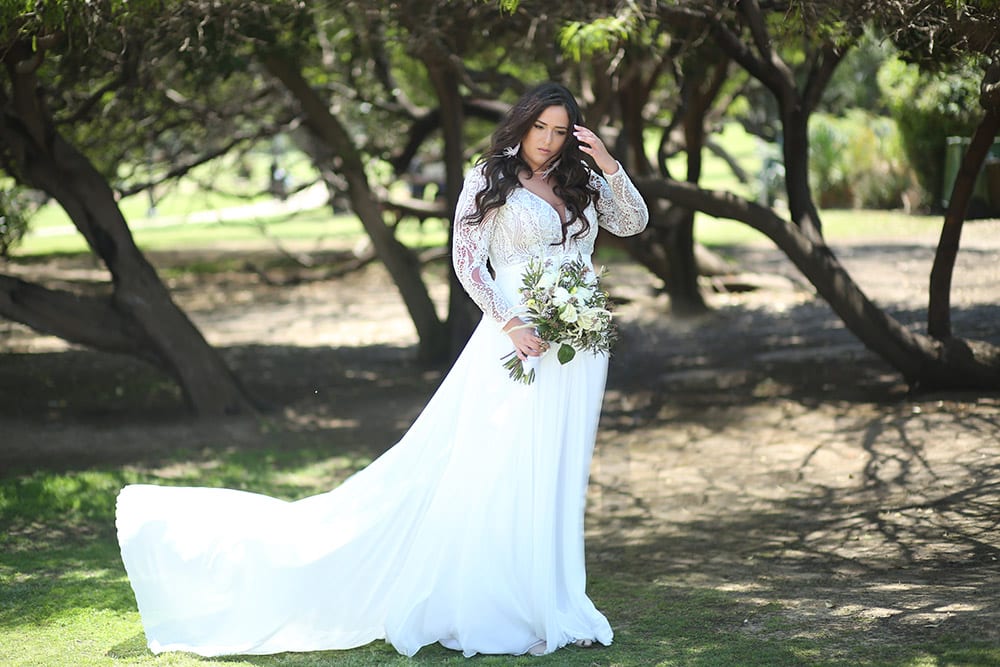 Margo by stodio levana plus size boho style wedding dress with long geometric lace sleeves amd a clean flowy skirt