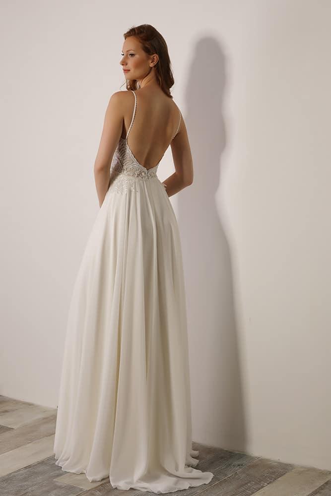 Polina by studio levana classick coutore bridel gown with open back baeded lace and a flowy nude and ivory skirt