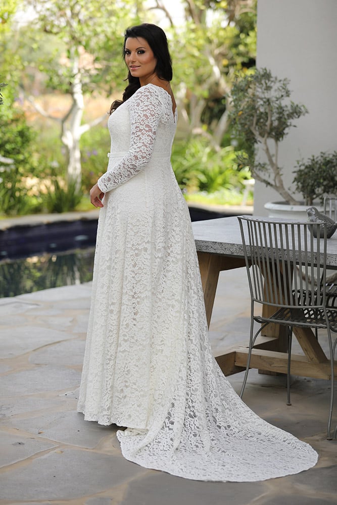 Seline by studio levana plus size all lace wedding dress with an A line skirt and a gental belt and long lace sleeves