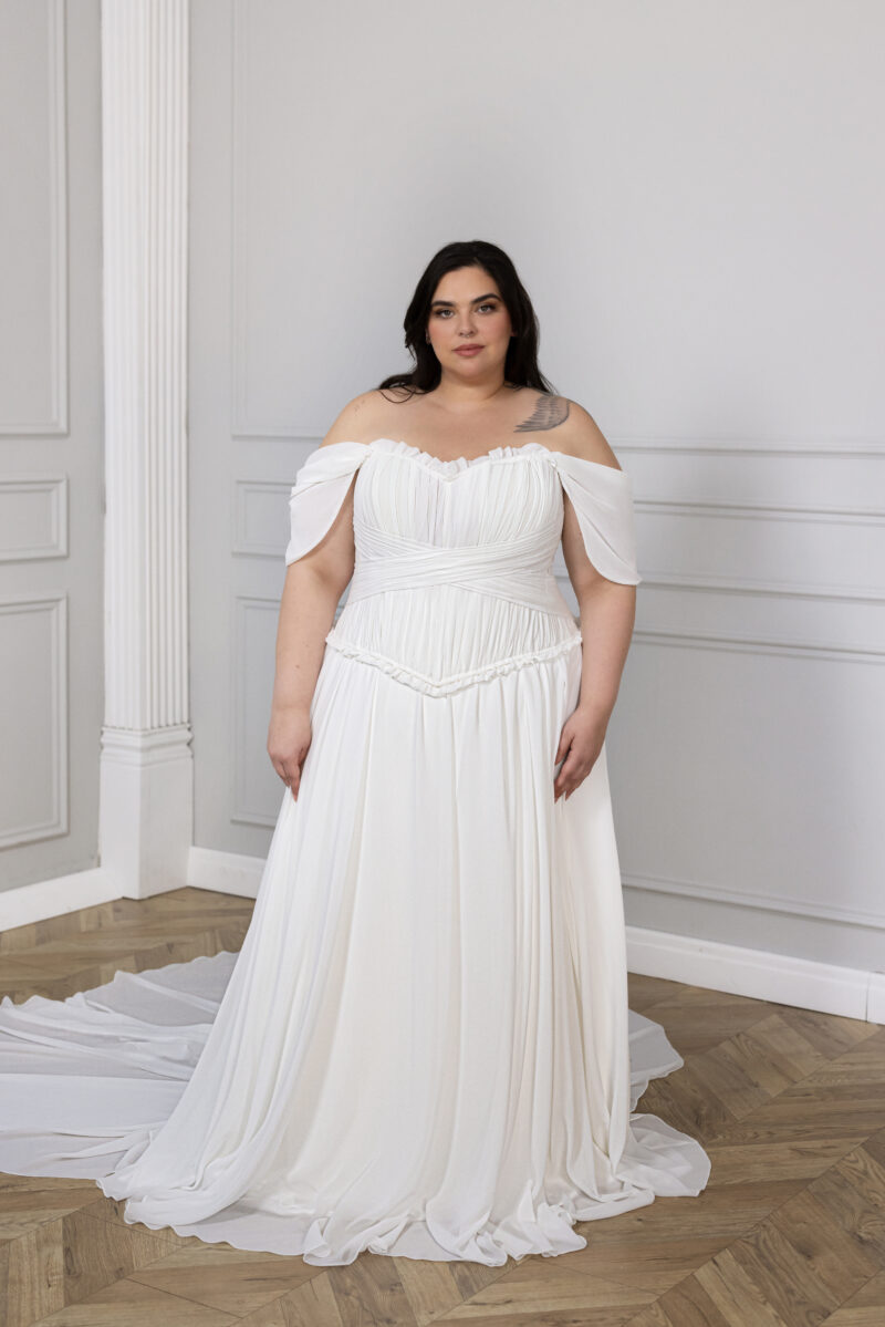 Figure-flattering ruched bodice with pleated tulle skirt on plus-size bridal gown