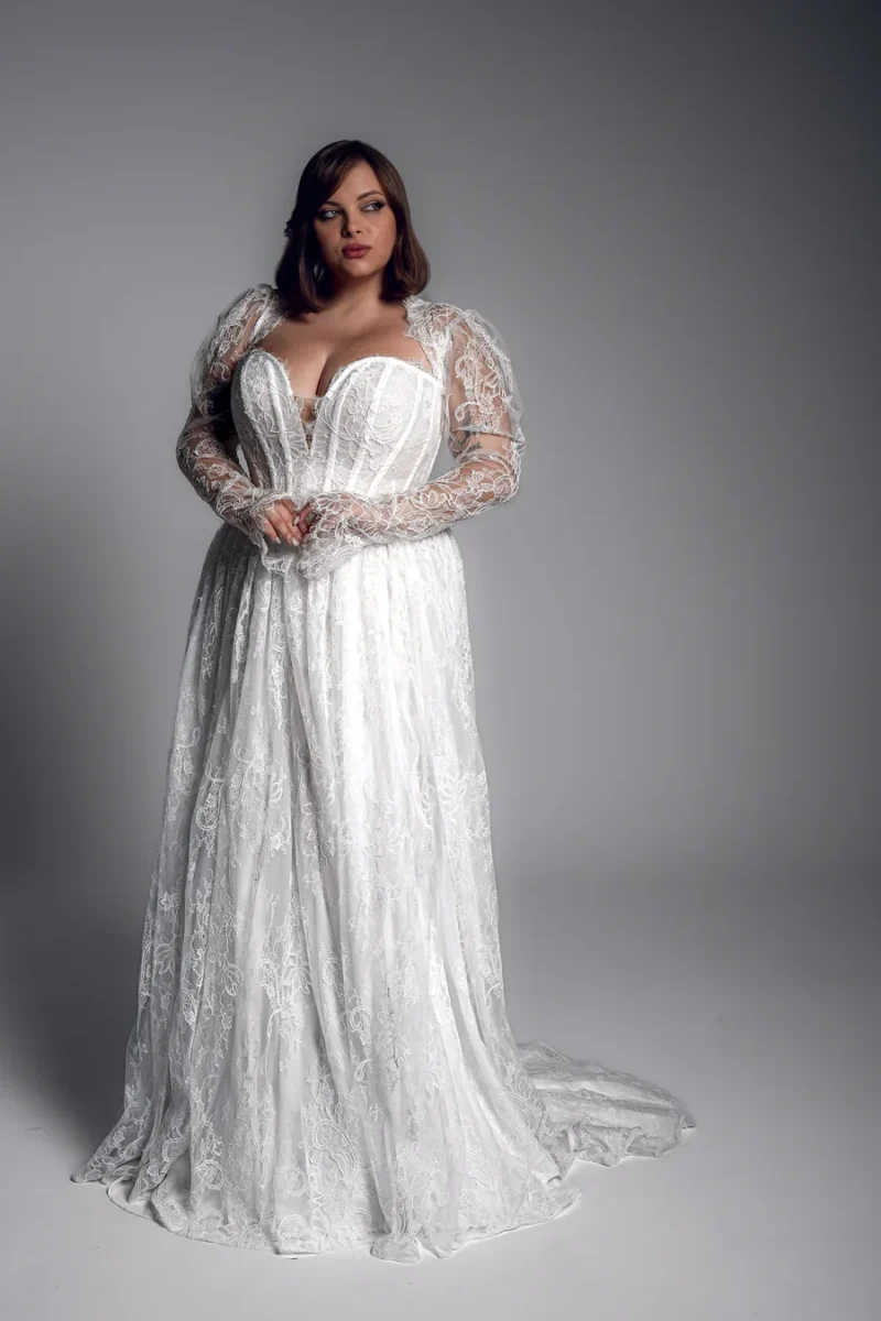 Studio Levana Anaise plus size lace A-line wedding dress with lace fabric and long lace sleeves, full-length front view
