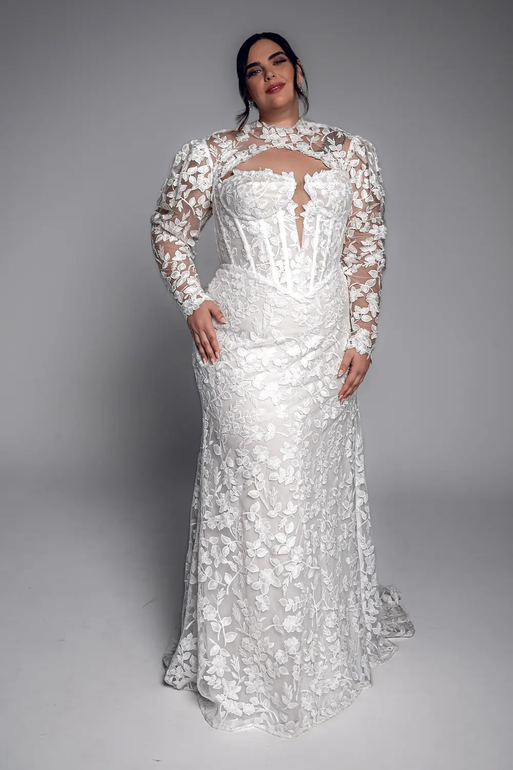 Studio Levana Corinne plus size lace fitted wedding dress with floral lace and long lace sleeves, full-length front view