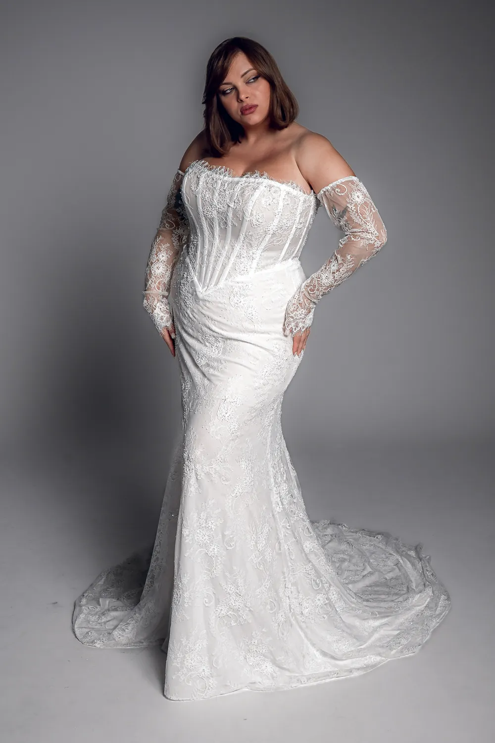Studio Levana Lise plus size lace fitted wedding dress with lace fabric and an off-the-shoulder neckline, full-length front view