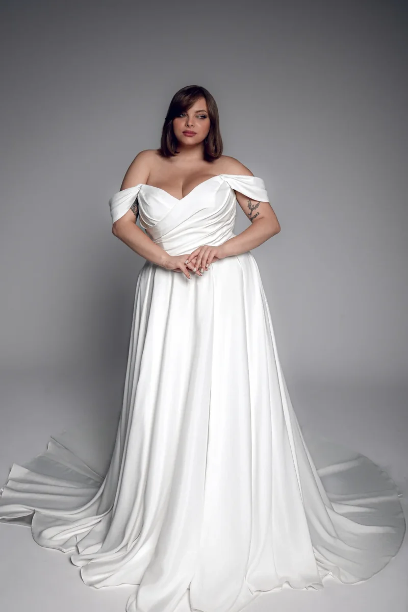 Studio Levana Manon plus size satin A-line wedding dress with draped satin and an off-the-shoulder neckline, full-length front view