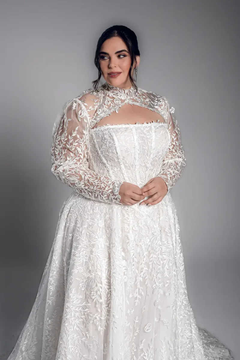 Studio Levana Noemia plus size embroidered lace A-line wedding dress with embroidered lace and long lace sleeves, front three-quarter view