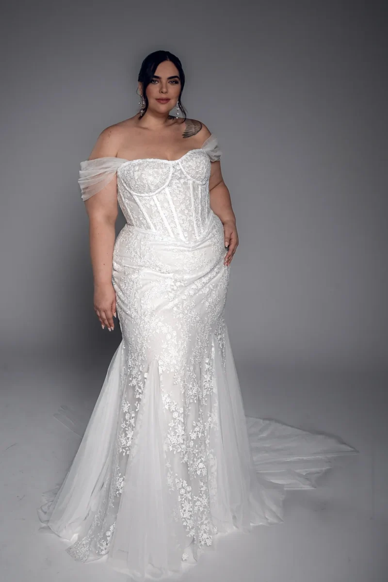 Studio Levana Yvette plus size lace fitted wedding dress with floral lace and an off-the-shoulder neckline, full-length front view